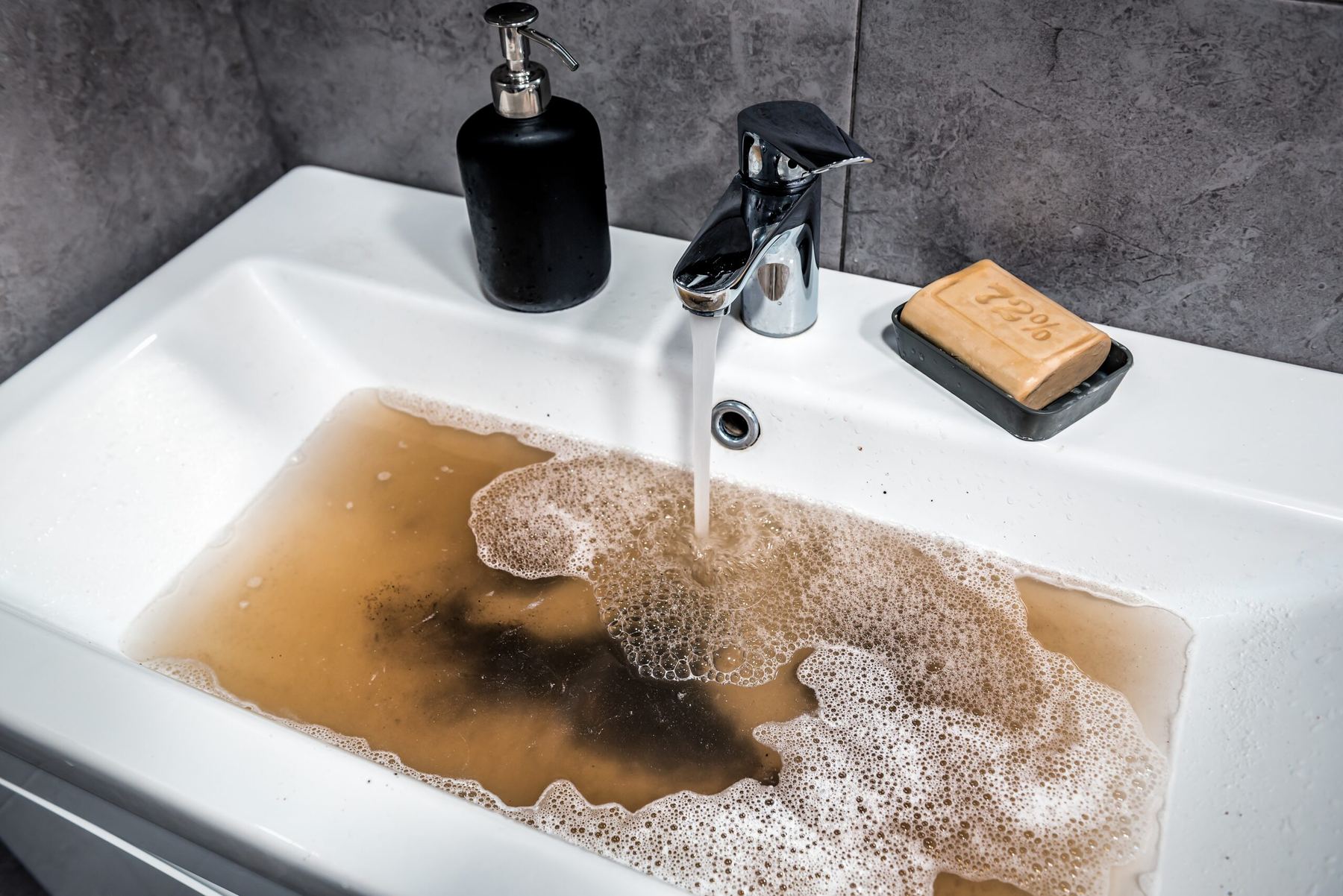 Bathroom sink basin filling with water