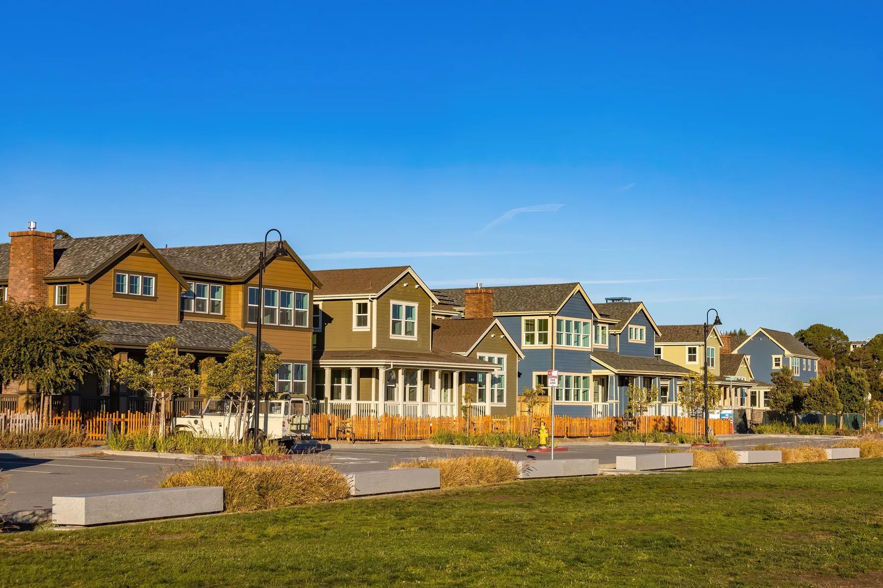 Row of new two-story suburban homes under a blue sky, like Pflugerville&rsquo;s master-planned neighborhoods