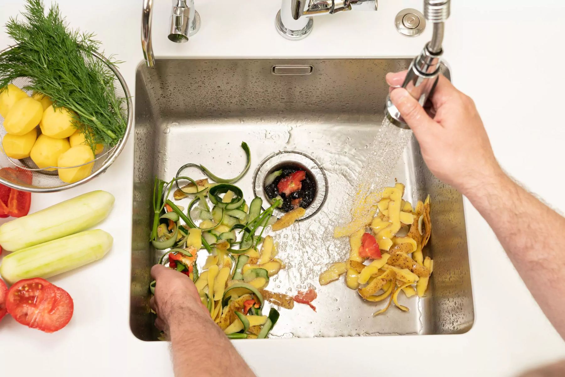 Plumber clearing a kitchen sink drain