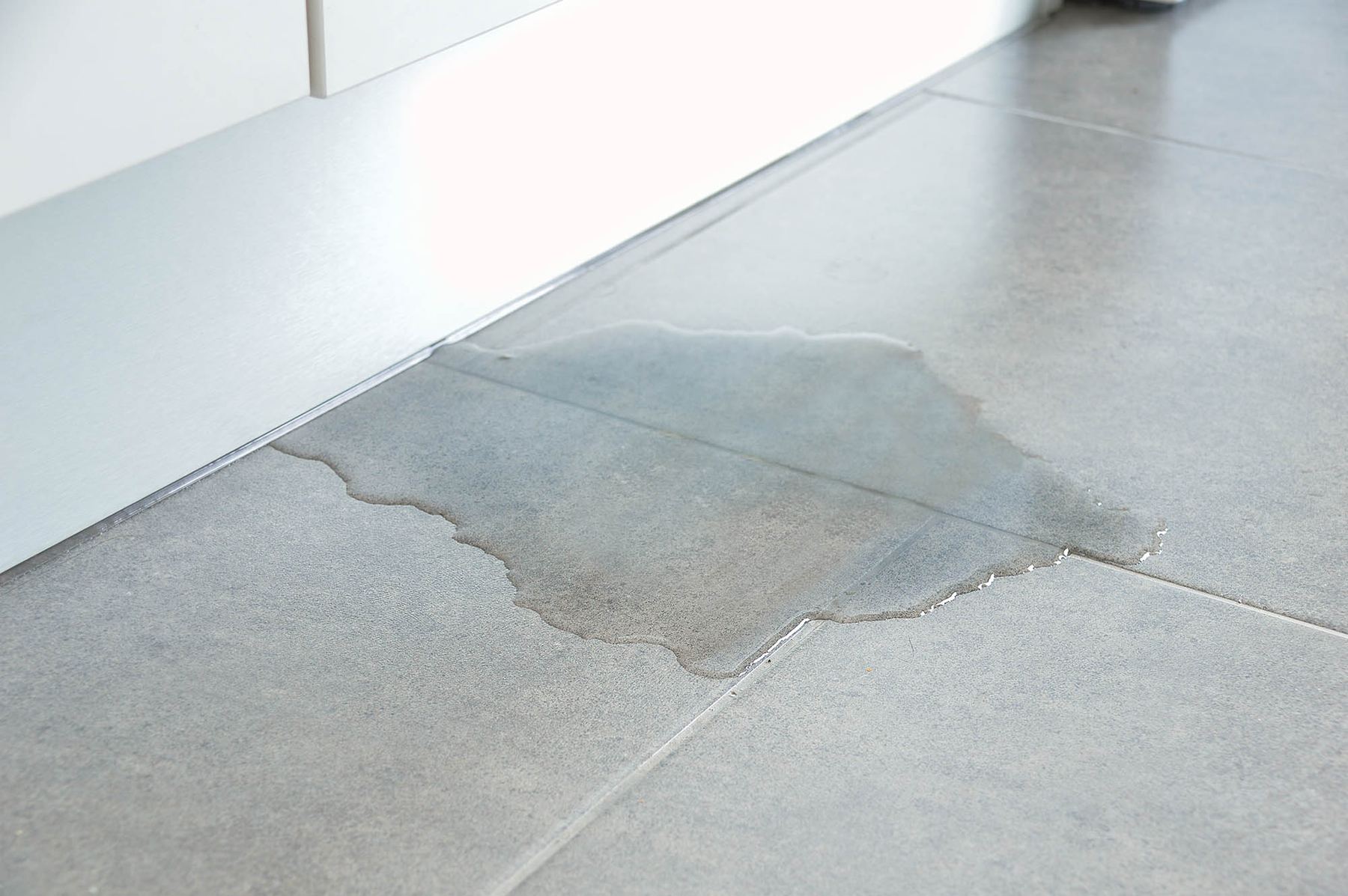 Water seeping up through a concrete slab floor